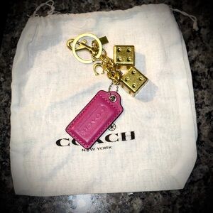 PINK COACH HANGTAG WITH GOLDEN DICE BAG CHARM + DUSTY